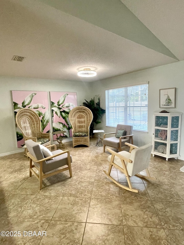 living room featuring visible vents and a textured ceiling