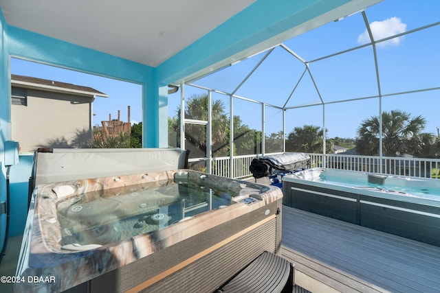 view of swimming pool with a deck, a lanai, and a hot tub