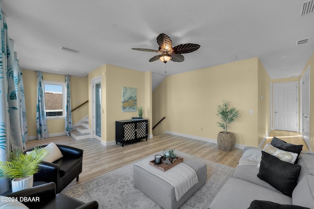 living room featuring ceiling fan and light hardwood / wood-style flooring