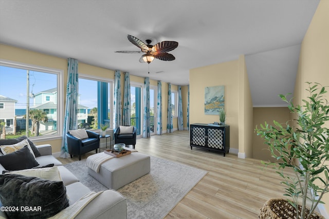 living room with light hardwood / wood-style floors and ceiling fan