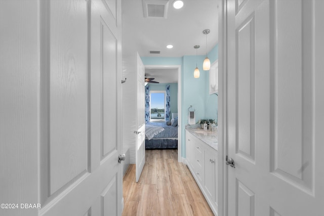 bathroom with vanity, hardwood / wood-style flooring, and ceiling fan