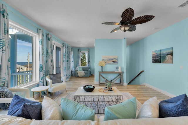 living room featuring light hardwood / wood-style floors and ceiling fan