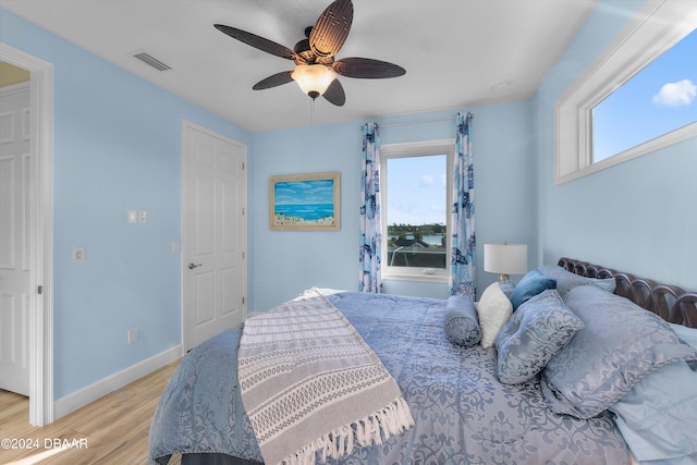 bedroom with ceiling fan and light hardwood / wood-style flooring