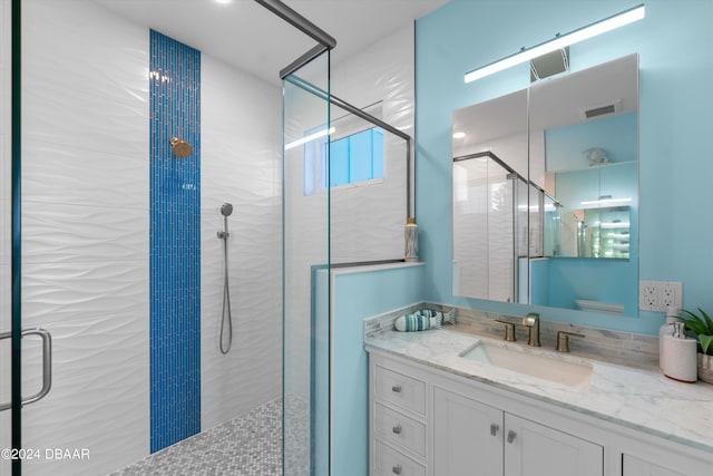 bathroom with an enclosed shower and vanity