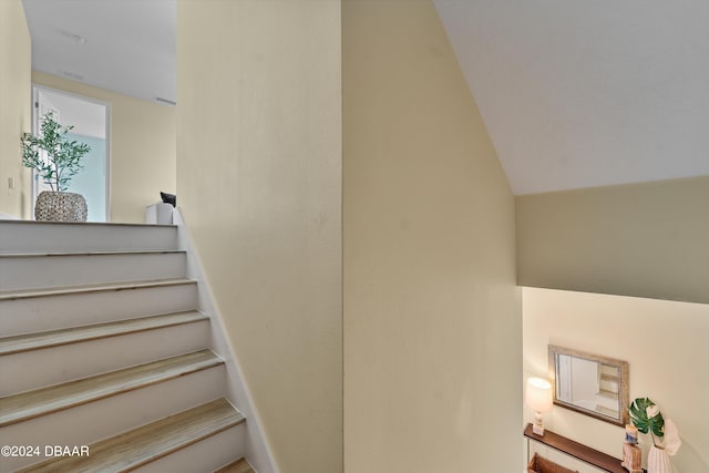 staircase featuring vaulted ceiling