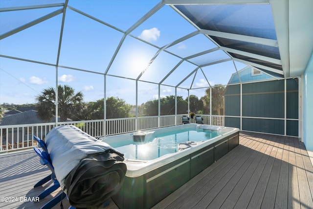 view of swimming pool with a deck and glass enclosure