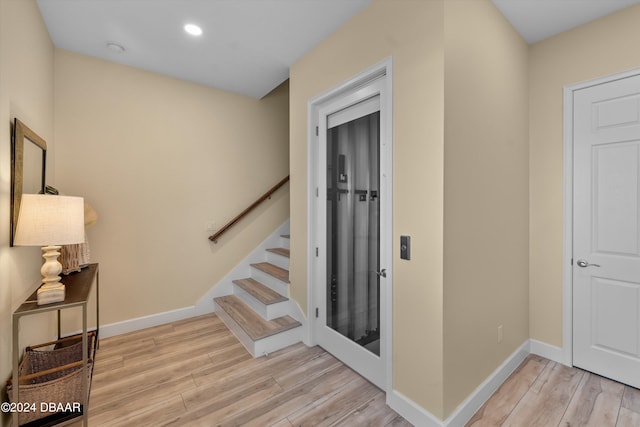 staircase featuring hardwood / wood-style flooring