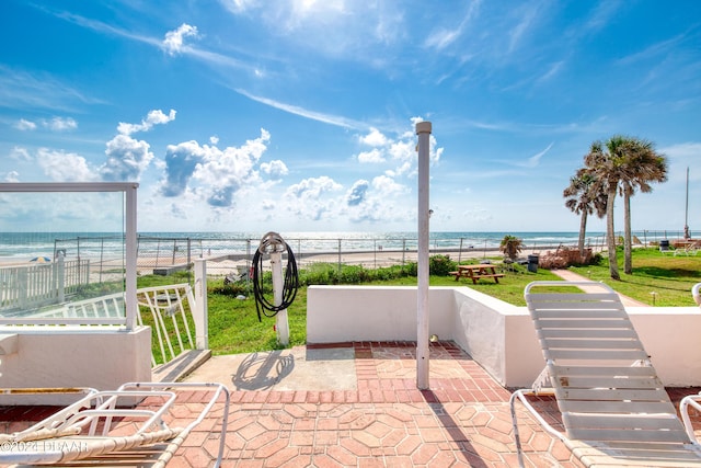 view of patio featuring a water view and a view of the beach