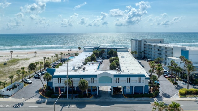 bird's eye view featuring a water view and a beach view