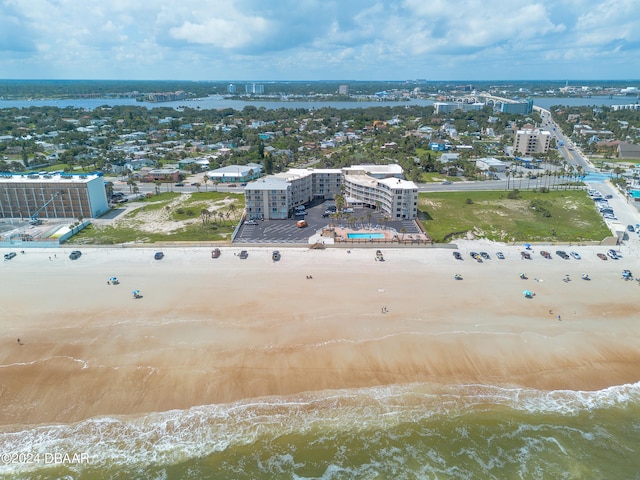 aerial view with a water view and a beach view