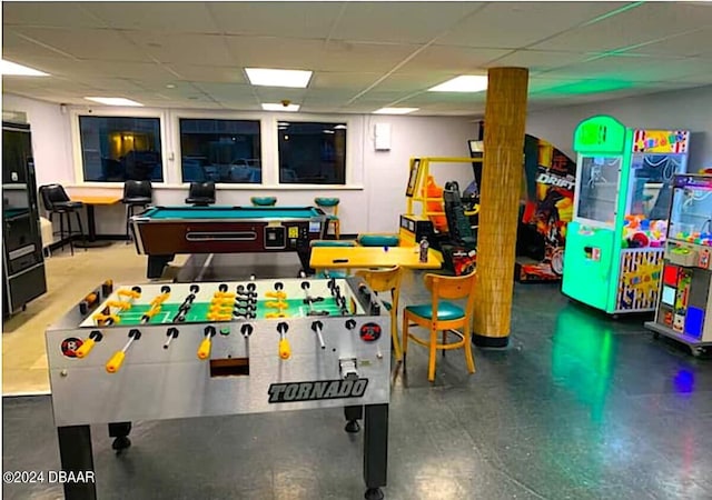 game room with a paneled ceiling