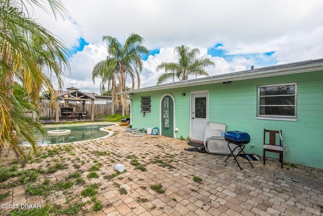 225 Sherwood Ln, Daytona Beach, FL 32117 - rear view of house featuring a gazebo, a fenced backyard, and a patio