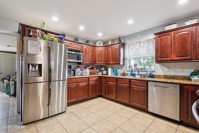 225 Sherwood Ln, Daytona Beach, FL 32117 - kitchen featuring stainless steel appliances, light tile patterned floors, stone countertops, and recessed lighting