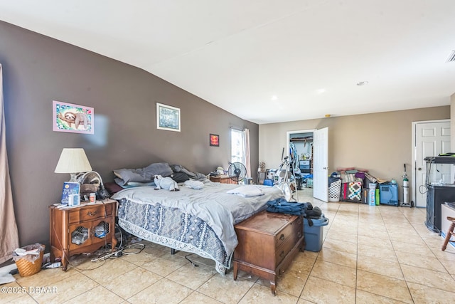225 Sherwood Ln, Daytona Beach, FL 32117 - bedroom with light tile patterned floors and vaulted ceiling