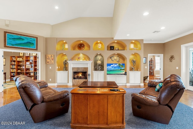 living room featuring tile patterned floors, crown molding, built in features, and vaulted ceiling