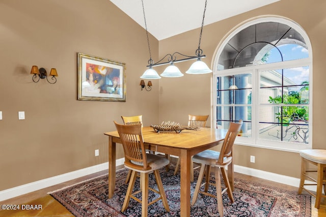 dining room with a healthy amount of sunlight and vaulted ceiling