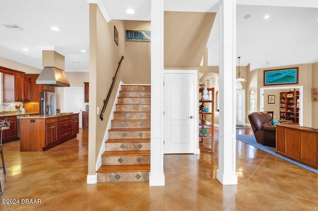 staircase with concrete floors, crown molding, and sink