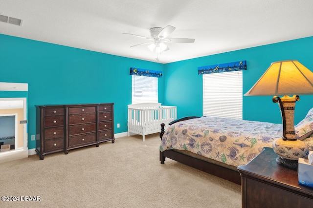 bedroom featuring light carpet and ceiling fan