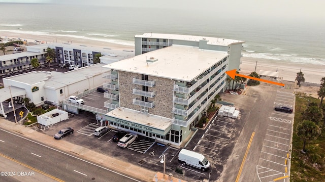 drone / aerial view with a water view and a view of the beach