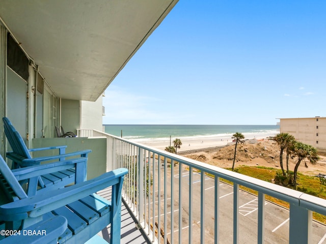 balcony featuring a water view and a view of the beach