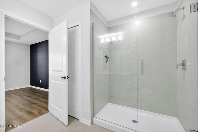 bathroom featuring hardwood / wood-style floors and a shower with shower door