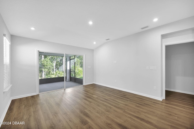 empty room with lofted ceiling and dark wood-type flooring