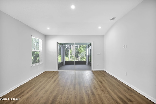 unfurnished room with dark hardwood / wood-style floors and plenty of natural light