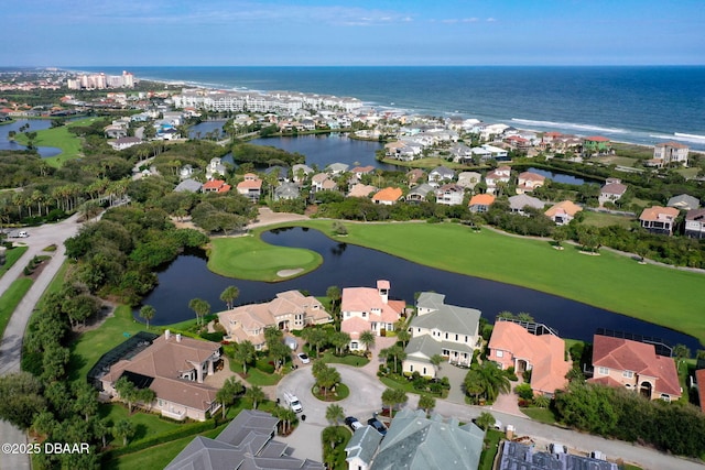 drone / aerial view featuring a water view, a residential view, and golf course view