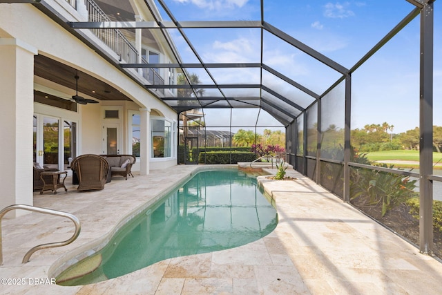 outdoor pool with a patio area, a lanai, and ceiling fan