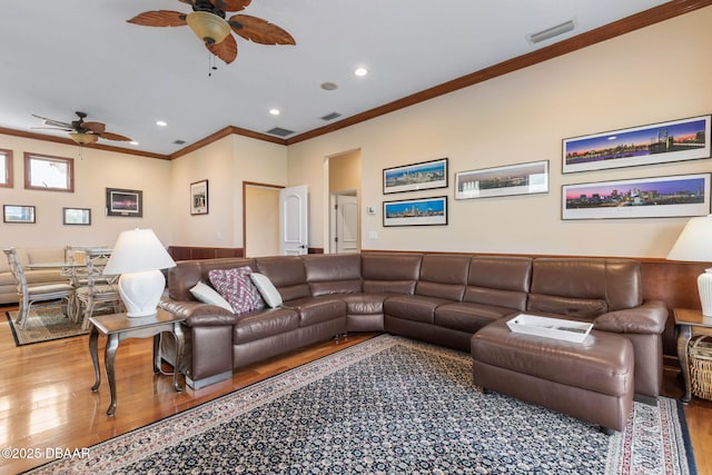 living area with ornamental molding, a ceiling fan, visible vents, recessed lighting, and wood finished floors