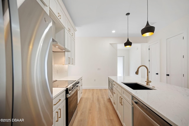 kitchen with white cabinetry, hanging light fixtures, stainless steel appliances, and sink