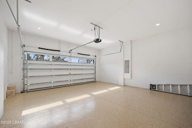 garage featuring a garage door opener and electric panel