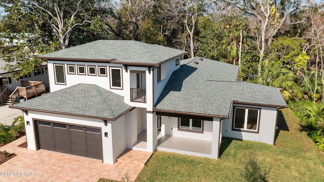 view of front of house with a balcony and a front yard