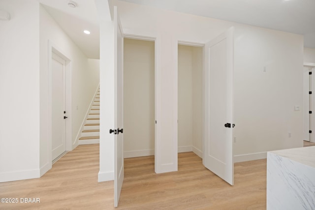 corridor with light wood-type flooring