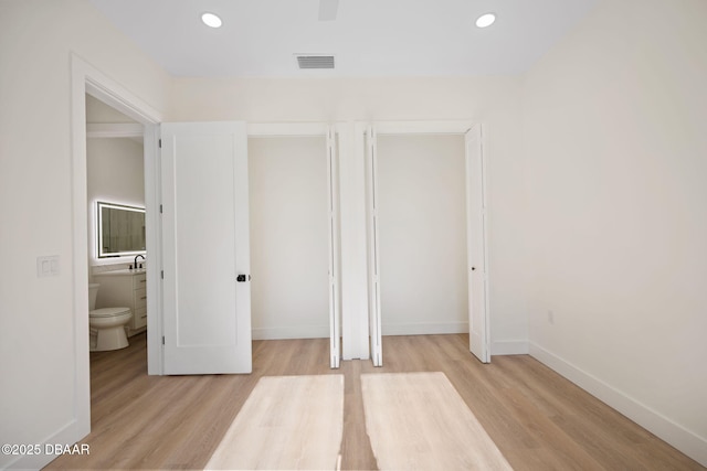 unfurnished bedroom with light wood-type flooring