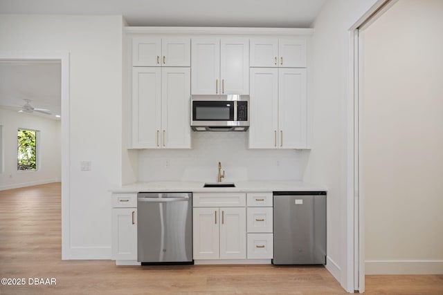 kitchen featuring sink, stainless steel appliances, and white cabinets