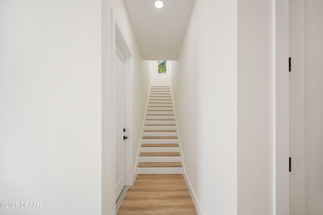 stairs featuring hardwood / wood-style floors