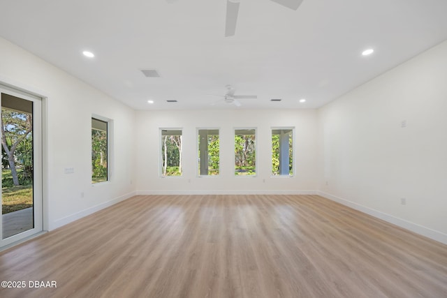 spare room featuring ceiling fan and light hardwood / wood-style flooring