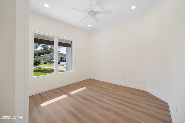 unfurnished room with ceiling fan and light wood-type flooring