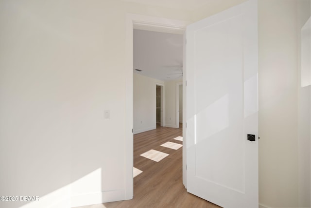 corridor with light wood-type flooring