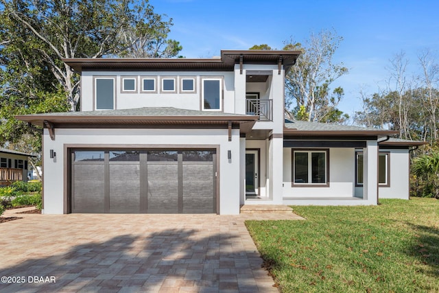 view of front of house with a garage, a front lawn, a balcony, and a porch