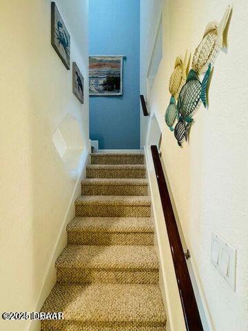 3000 Ocean Shore Blvd Unit 15, Ormond Beach, FL 32176 - stairway featuring carpet