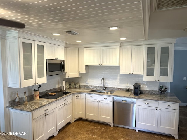 kitchen featuring stainless steel appliances, white cabinetry, and sink