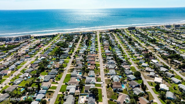 birds eye view of property featuring a water view and a view of the beach