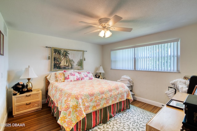 bedroom featuring hardwood / wood-style flooring, a textured ceiling, and ceiling fan