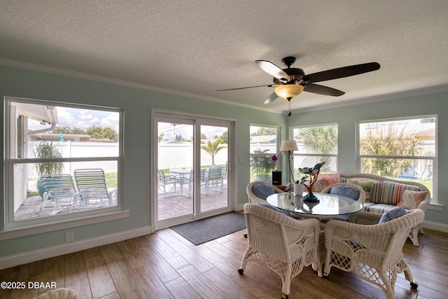 sunroom featuring ceiling fan