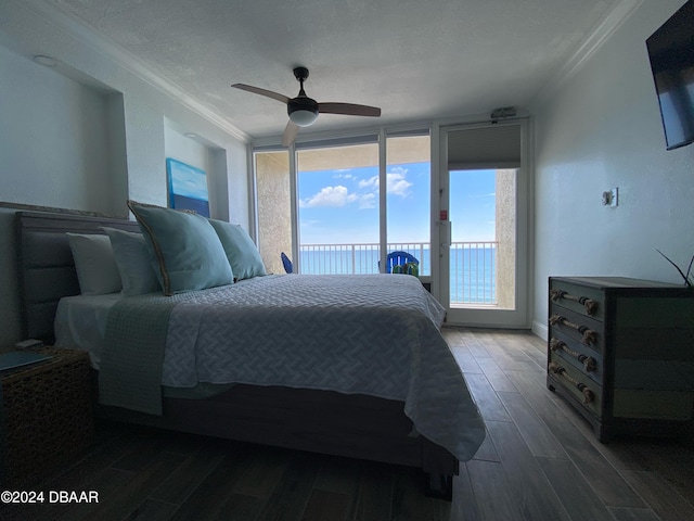 bedroom featuring dark hardwood / wood-style flooring, access to exterior, a textured ceiling, ceiling fan, and crown molding