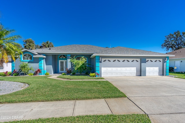 ranch-style home with a garage and a front lawn