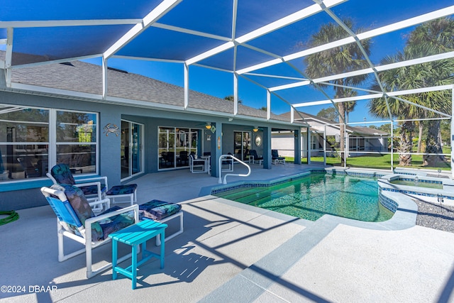 view of pool with ceiling fan, a lanai, and a patio