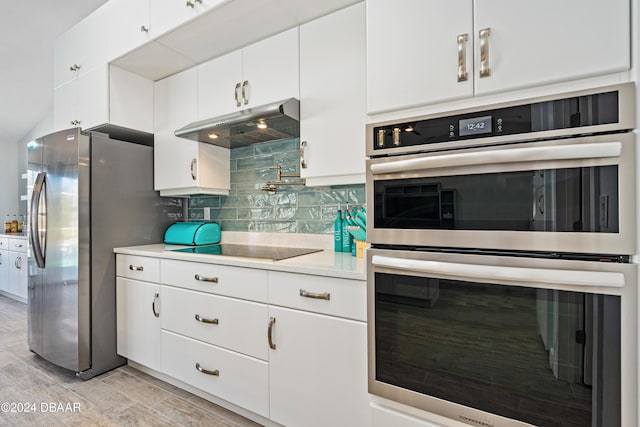 kitchen with backsplash, white cabinetry, light hardwood / wood-style floors, and appliances with stainless steel finishes